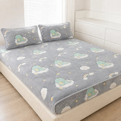 A gray plush bed sheet set with matching pillowcases, featuring a cute cartoon cloud and dinosaur pattern, styled on a bed in a bright, modern bedroom.
