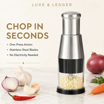 CHOPSNAP™ manual food chopper with stainless steel body, filled with chopped garlic, surrounded by onion, garlic, chilli and carrot
