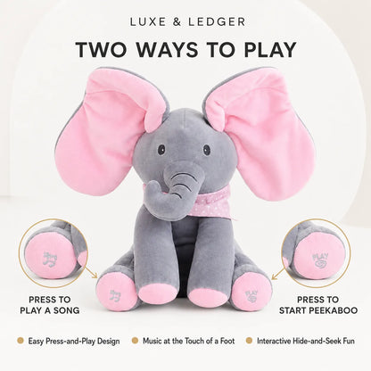 Peek-A-Boo Singing Elephant Pink variant — front product shot, grey plush with pink ears, ears spread wide open