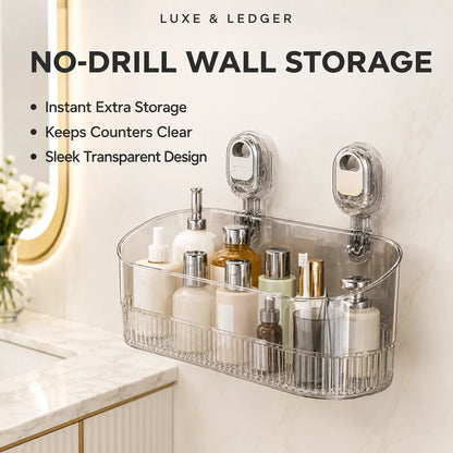 A clear acrylic no-drill wall storage basket mounted on a bathroom wall, holding assorted toiletries. The image includes marketing text at the top reading 'LUXE & LEDGER' and 'NO-DRILL WALL STORAGE' with bullet points about instant extra storage, clear counter space, and transparent design.