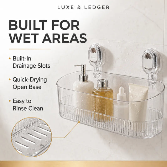 Clear acrylic bathroom wall-mounted basket with suction cups, shown holding soap and lotion bottles on a tiled wall. Text highlights wet-area suitability, drainage slots, quick-drying open base, and easy rinsing.