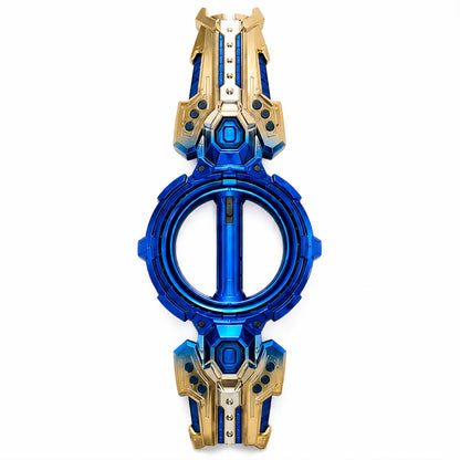 A futuristic toy watch or accessory with a circular blue center and symmetrical gold and blue outer sections, shown on a plain white background.