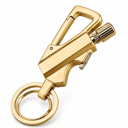 A gold-finished metal keychain tool with a carabiner clip, small lever, textured side knob, and attached key ring on a plain white background.