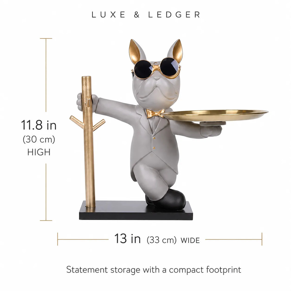 A decorative figurine of a gray cat in a gray suit with gold sunglasses, bow tie, and gold ears, holding a gold tray while standing next to a gold tree stand on a black base. The image includes dimension lines showing 11.