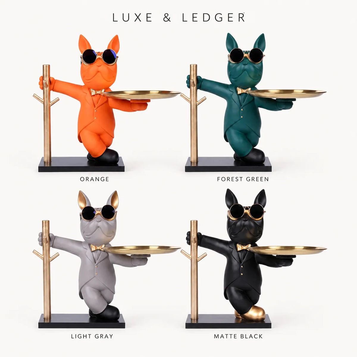Four decorative cat figurines in suits holding gold trays, shown in orange, forest green, light gray, and matte black on a white background with the text 'LUXE & LEDGER' and color labels below each figure.