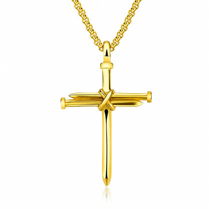 A gold cross pendant necklace featuring a stylized sword and nail design, suspended from a gold chain against a plain white background.