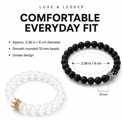 Two beaded stretch bracelets on a white background with text reading 'COMFORTABLE EVERYDAY FIT' and size details. One bracelet is white with a gold crown charm, and the other is black with a silver-toned decorative end piece.