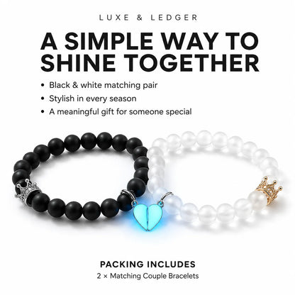Two matching beaded stretch bracelets on a white background with promotional text. One bracelet is matte black with a glowing light-blue heart charm and silver crown detail, and the other is white with a pearl-like bead, gold crown detail, and a small silver heart charm.