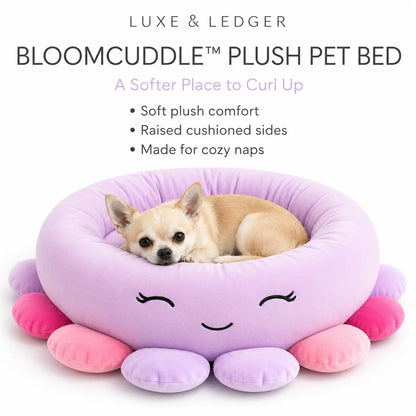 A small tan dog rests inside a lavender plush pet bed with pink and purple petal-like sides. The image includes marketing text at the top reading 'LUXE & LEDGER' and 'BLOOMCUDDLE PLUSH PET BED' on a white background.