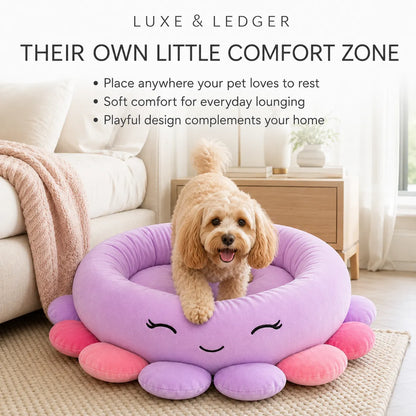A small tan dog stands in a round lavender pet bed with pink and purple tent-like feet and a smiling face, placed on a rug in a bright living room. Text at the top reads 'LUXE & LEDGER' and 'THEIR OWN LITTLE COMFORT ZONE' with bullet points about comfort and playful design.
