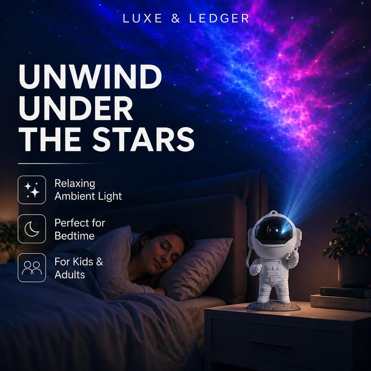 A bedroom scene with a woman sleeping under a colorful galaxy projection on the wall. On the bedside table sits an astronaut-shaped night light projecting blue and purple starlight.
