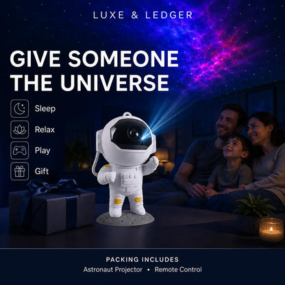 An astronaut-shaped projector toy displayed in a living room scene, projecting a colorful galaxy pattern onto the wall above a family sitting and watching. The image includes promotional text reading 'GIVE SOMEONE THE UNIVERSE' and 'LUXE & LEDGER'.