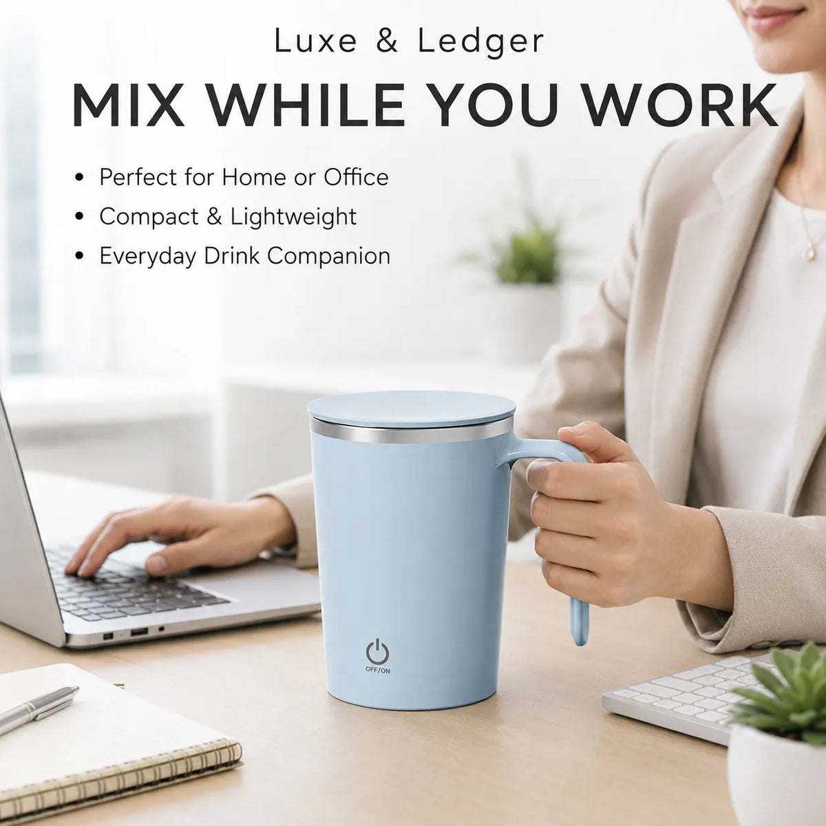 A light blue electric mixing mug with a lid and handle sits on a desk in a home office setting, with a woman holding the handle and working on a laptop. Text at the top reads 'Luxe & Ledger MIX WHILE YOU WORK'.