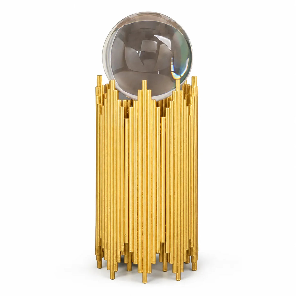 A modern decorative object featuring a clear glass sphere resting on a base made of many vertical gold rods, shown against a plain white background.