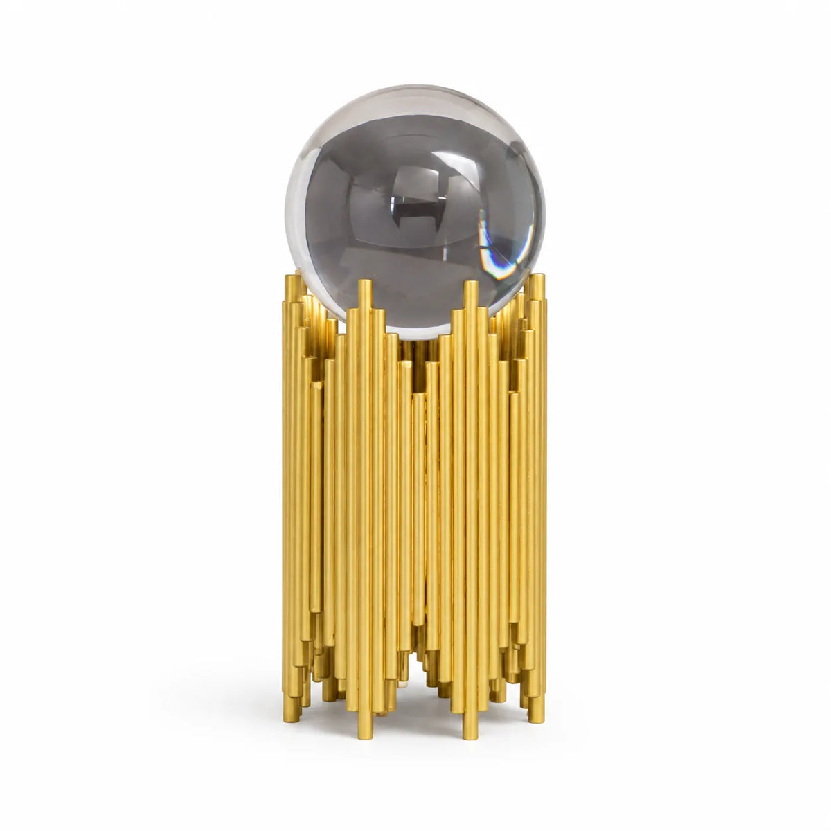 A modern decorative sculpture featuring a polished silver reflective sphere resting on a cylindrical base made of numerous vertical gold rods, set against a plain white background.
