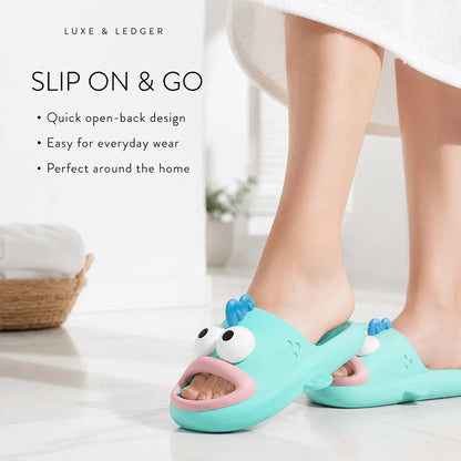 A person wearing a turquoise cartoon fish slip-on sludge with a pink mouth and white eyes, standing on a white tiled floor. The image includes text overlays describing the slip-on design and features, with a white towel at the top and a basket in the background.
