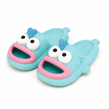 A pair of light blue children's slide sandals shaped like cartoon fish with large white cartoon eyes, pink mouths, and small blue hair-like accents, shown on a clean white background.