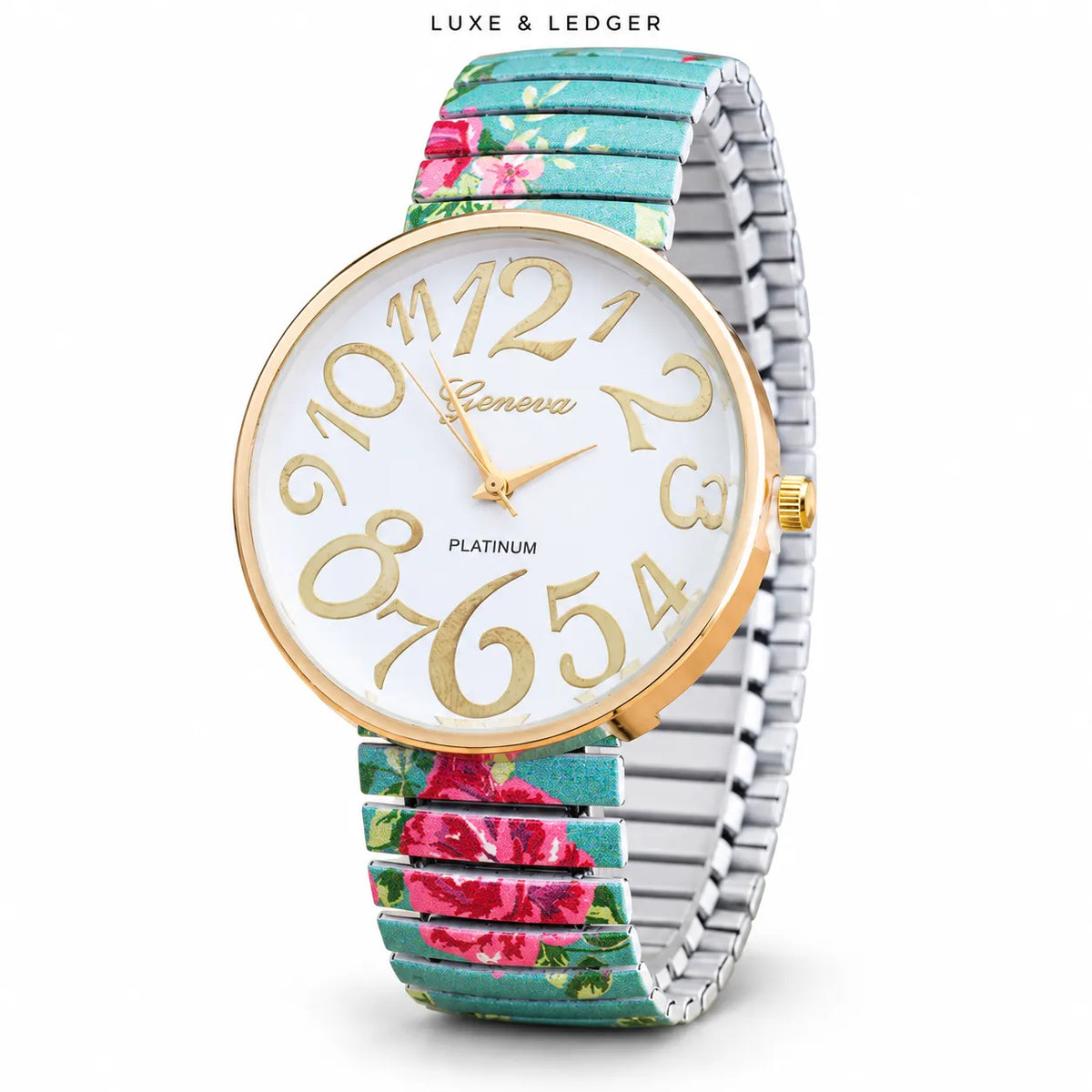 A women's analog watch by Luxe & Ledger, featuring a round gold-tone bezel, a white dial with gold Arabic numerals and hands, and a silver-toned metal link bracelet with a turquoise floral print.