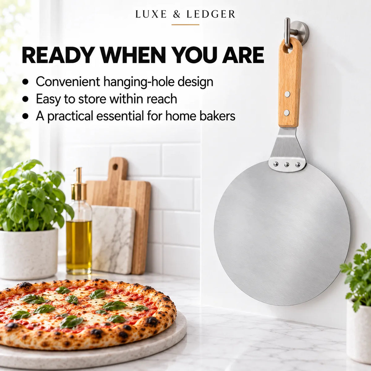 A stainless steel pizza peel with a light wood handle hangs on a wall hook in a bright kitchen setting. The left side includes promotional text and a pizza on a stone board, with potted plants and cutting boards in the background.