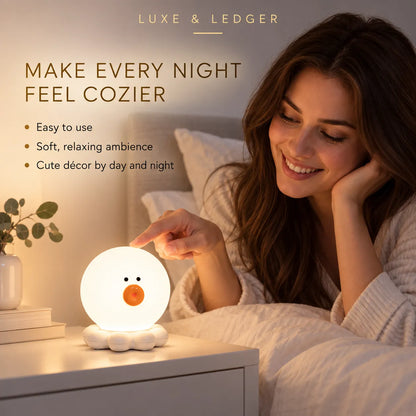 A woman in a cozy bed setting touches a glowing, duck-shaped night light on a bedside table. The product is illuminated with a soft white body and a small orange beak, with text at the top reading 'LUXE & LEDGER' and promotional copy about making every night feel cozier.