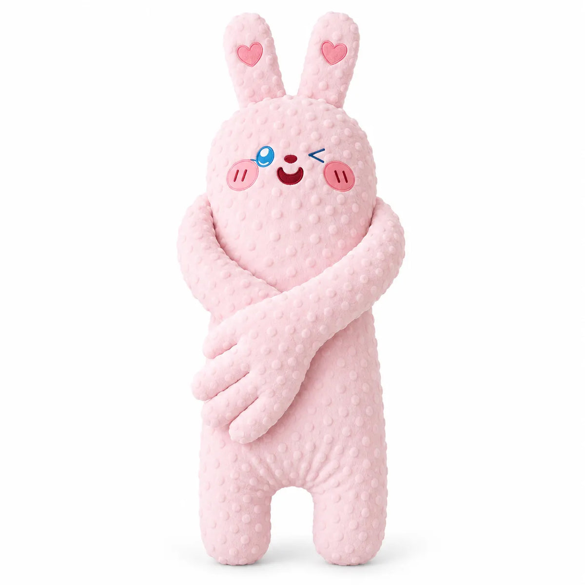 A pink plush bunny toy with a textured, dotted minky fabric, featuring embroidered eyes, a winking smiley face, pink cheeks, and heart details on its ears, set against a plain white background.
