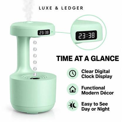 A mint green portable humidifier and digital clock shown on a white background with marketing text and icons. The product has a clear digital time display reading 23:38, a circular inset showing the top lid with the clock screen, and text stating 'TIME AT A GLANCE' plus features like clear digital clock display, functional modern decor, and easy to see day or night.