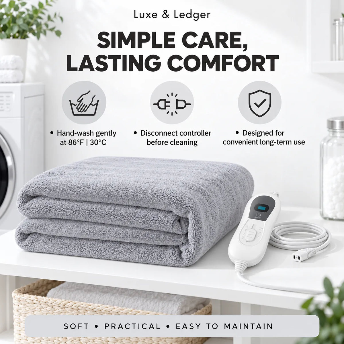 A folded light gray electric blanket throw is displayed on a white shelf next to its white remote control and cable. The background shows a clean laundry room setting with a washing machine and a jar of cotton balls.