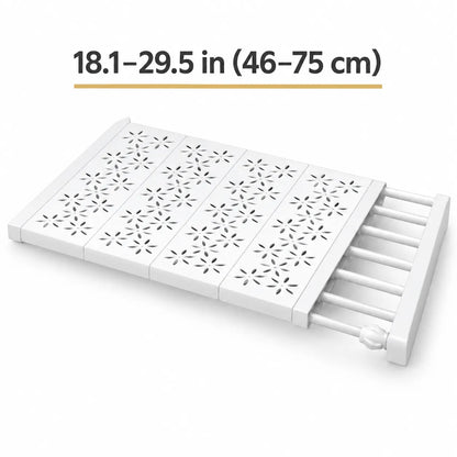White plastic folding slide-out storage tray with star-shaped cutout patterns on the top surface, shown partially extended with text above reading 18.1-29.