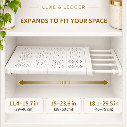 White under-shelf cabinet organizer tray shown installed inside a white cabinet, with text indicating expandable width and three size measurements in inches and centimeters.