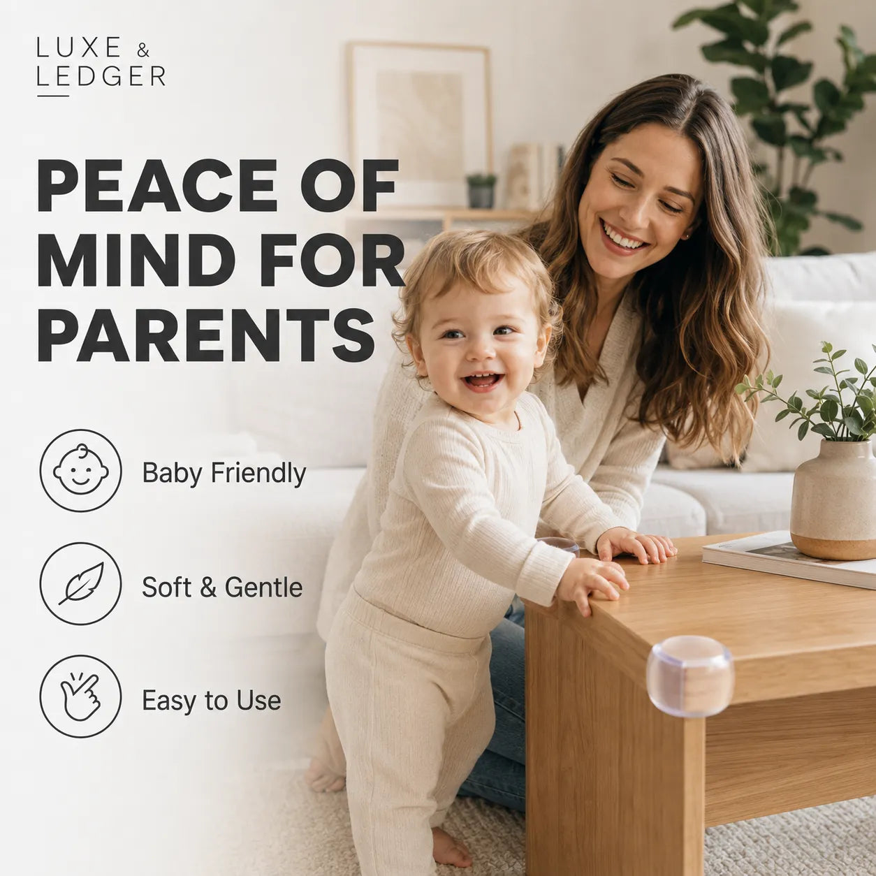 A woman and a baby in matching cream-colored loungewear are sitting on a sofa in a bright living room, with a small round product shown resting on the wooden coffee table in the foreground. Large text on the left reads 'PEACE OF MIND FOR PARENTS' with icons for 'Baby Friendly,' 'Soft & Gentle,' and 'Easy To Use.