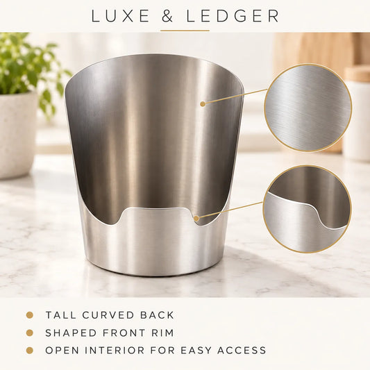 A brushed stainless steel cup or tumbler with a curved back and shaped front rim, shown on a light marble surface with two circular detail insets highlighting the finish. Text at the top reads 'LUXE & LEDGER' and bullet points at the bottom describe the tall curved back, shaped front rim, and open interior for easy access.