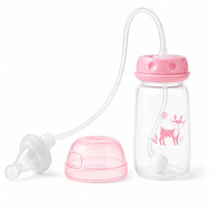 A clear baby bottle with a pink screw-on lid, a clear feeding tube, a pink cap, and a clear nipple, shown on a white background. The bottle has a pink deer graphic printed on the side.