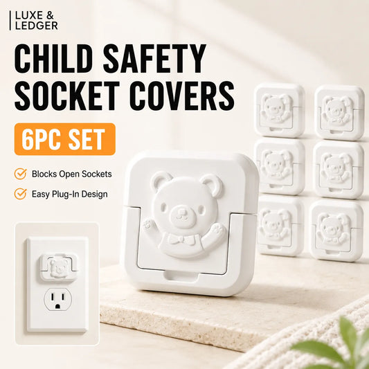 A set of six white child safety socket covers with a cute bear face design, displayed on a light beige surface next to an inset showing one cover plugged into a wall outlet. The image includes text overlays reading 'LUXE & LEDGER' and 'CHILD SAFETY SOCKET COVERS 6PC SET'.