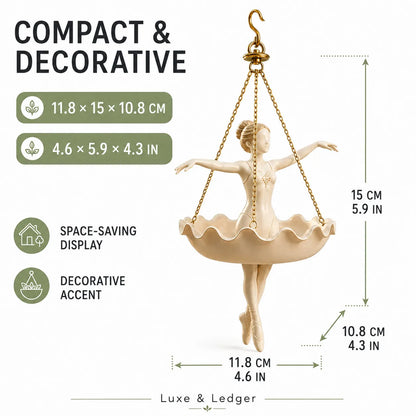 A beige ballerina figurine hanging from gold chains, shown with overlaid dimension lines and text reading 'COMPACT & DECORATIVE' and measurements in centimeters and inches. The Luxe & Ledger brand name appears at the bottom.
