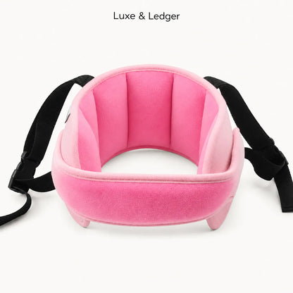 A pink padded neck support pillow with black adjustable straps, shown on a clean white background with 'Luxe & Ledger' text at the top.