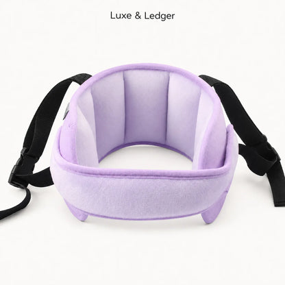 A light purple plush neck pillow with black adjustable straps, shown against a plain white background with 'Luxe & Ledger' text at the top.