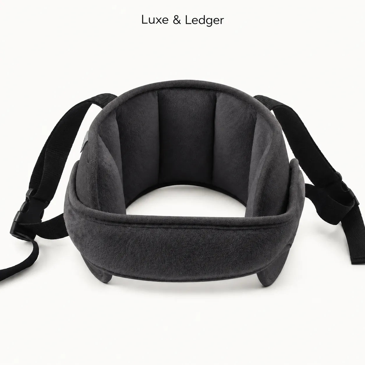 A dark gray and black padded neck support pillow with adjustable straps, shown on a clean white background with 'Luxe & Ledger' text at the top.