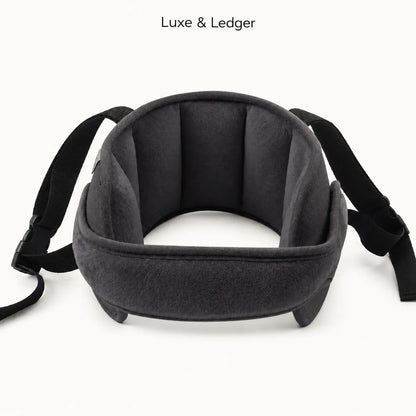 A dark gray and black padded neck support pillow with adjustable straps, shown on a clean white background with 'Luxe & Ledger' text at the top.