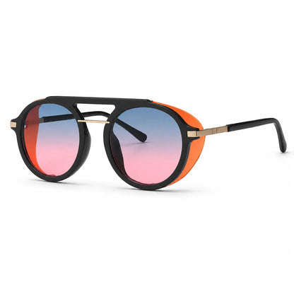 Aviator-style sunglasses with a black double-bridge frame, bright orange side accents, gold metal temples, and pink-to-blue gradient lenses.