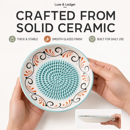 A pair of hands holds a round white ceramic dish with a textured turquoise center and black and orange scrollwork. The image includes marketing text at the top reading 'CRAFTED FROM SOLID CERAMIC' and a small inset showing the dish from above.