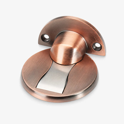 A copper-finished door stopper with a brushed metal circular base, a curved mounting plate, and a central cylindrical rod, shown on a light gray background.