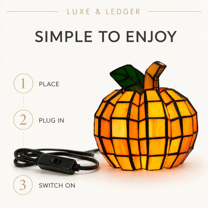 An illuminated stained-glass pumpkin lamp with a black power cord and switch, shown on a light beige background with text reading 'SIMPLE TO ENJOY' and step-by-step instructions.
