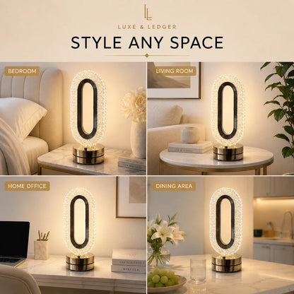 A 2x2 collage showing a modern oval LED table lamp in four real-world settings: bedroom, living room, home office, and dining area. The lamp has a black oval center surrounded by a clear faceted crystal-like ring, mounted on a metallic gold base.