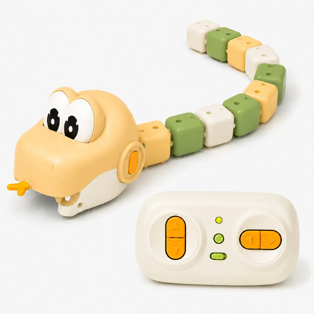 A toy snake-shaped robot with a beige head, green and white block segments, and a separate cream-colored remote control on a plain white background.