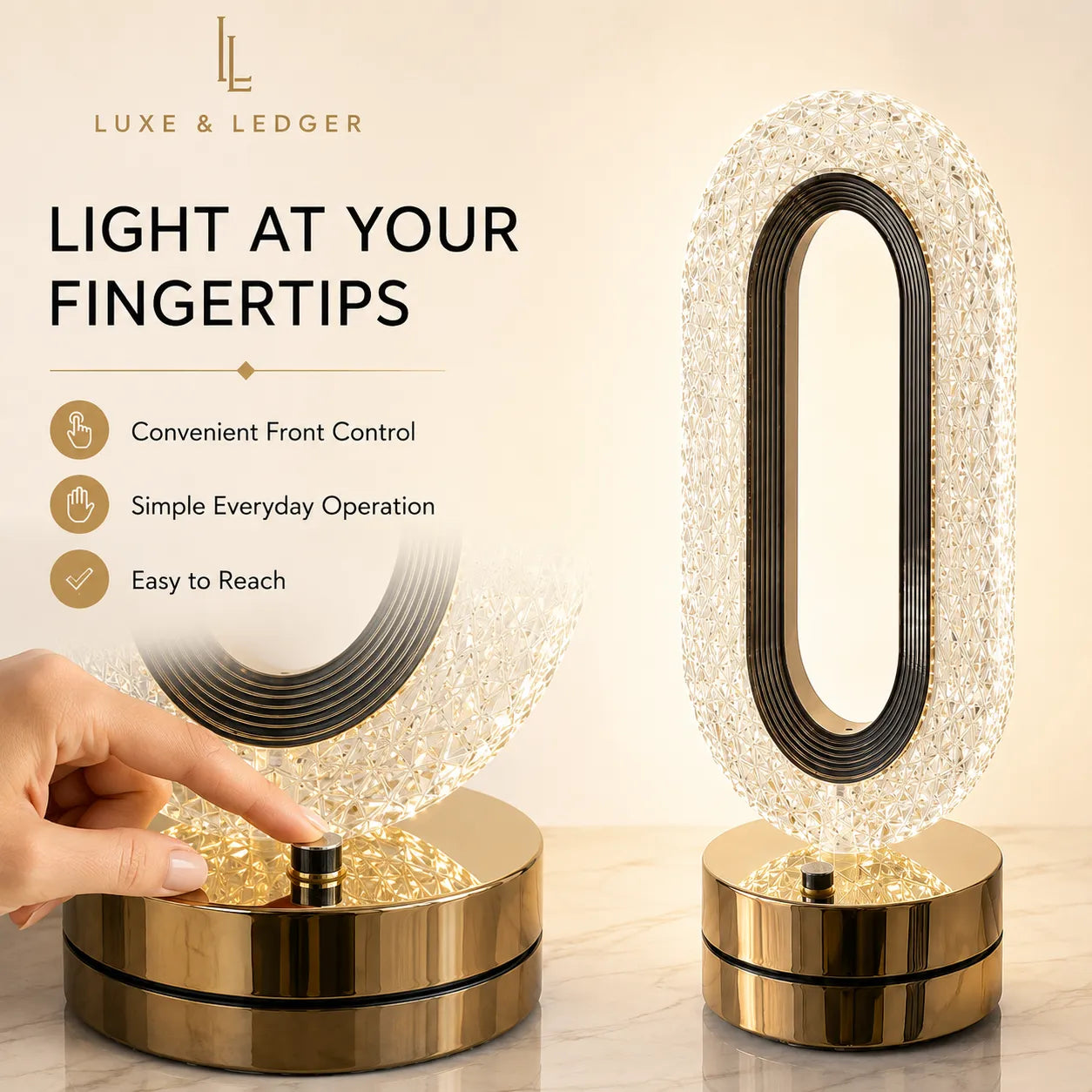 A Luxe & Ledger modern oval LED table lamp with a clear faceted crystal-like outer frame, black inner ring, and a shiny gold circular base. A hand is shown touching the top button on the left lamp, while a second lamp stands on the right.