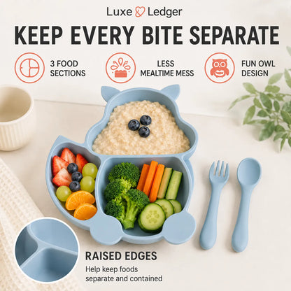 A light blue owl-shaped baby feeding tray set on a light beige tabletop, filled with oatmeal, fruit, broccoli, carrots, and cucumber sticks, alongside matching blue utensils. Text at the top reads 'Luxe Ledger' and 'KEEP EVERY BITE SEPARATE,' with feature icons and a close-up inset showing raised edges.