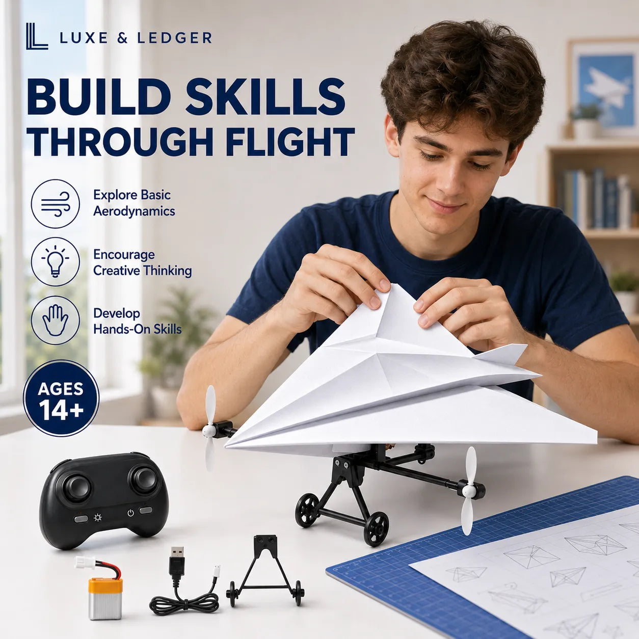 A man sits at a table building a white paper airplane with a black remote-controlled plane and accessories in front of him. Large text on the left reads 'BUILD SKILLS THROUGH FLIGHT' with feature icons and 'AGES 14+'.