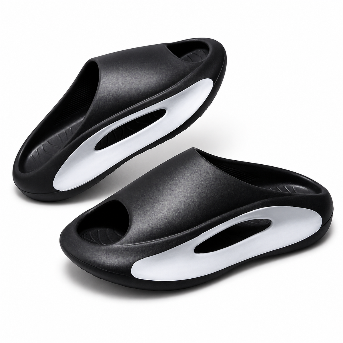 A pair of black and white slide sandals with a modern, sculpted sole design, displayed on a clean white background.