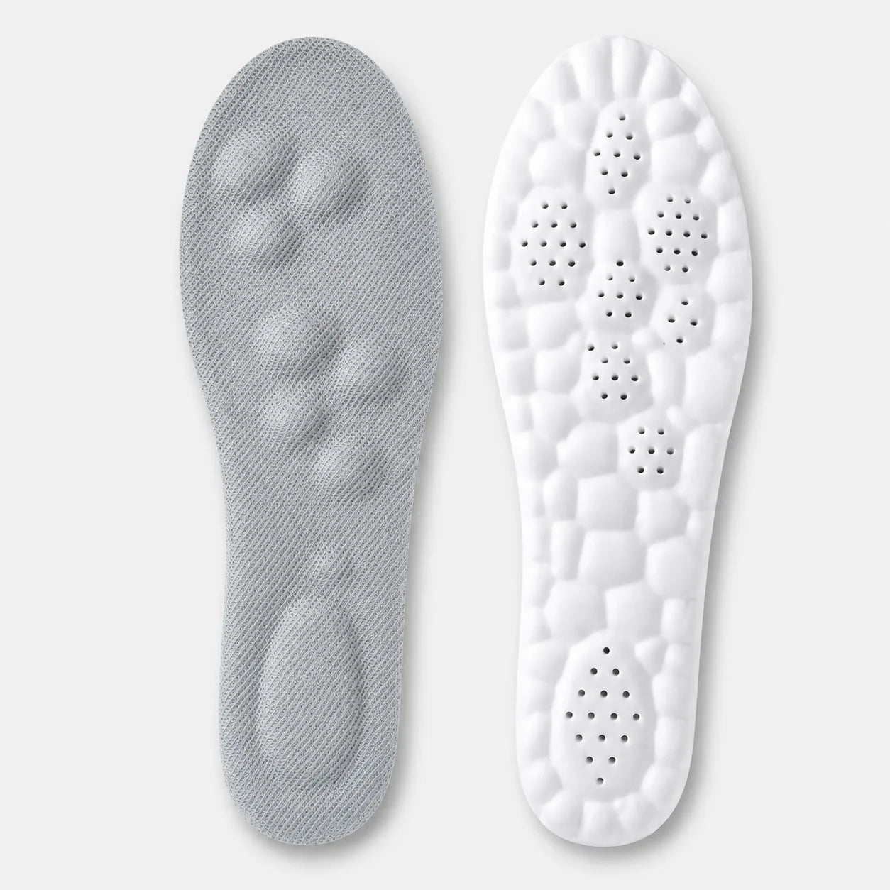 Gray and white shoe insoles on a light gray background