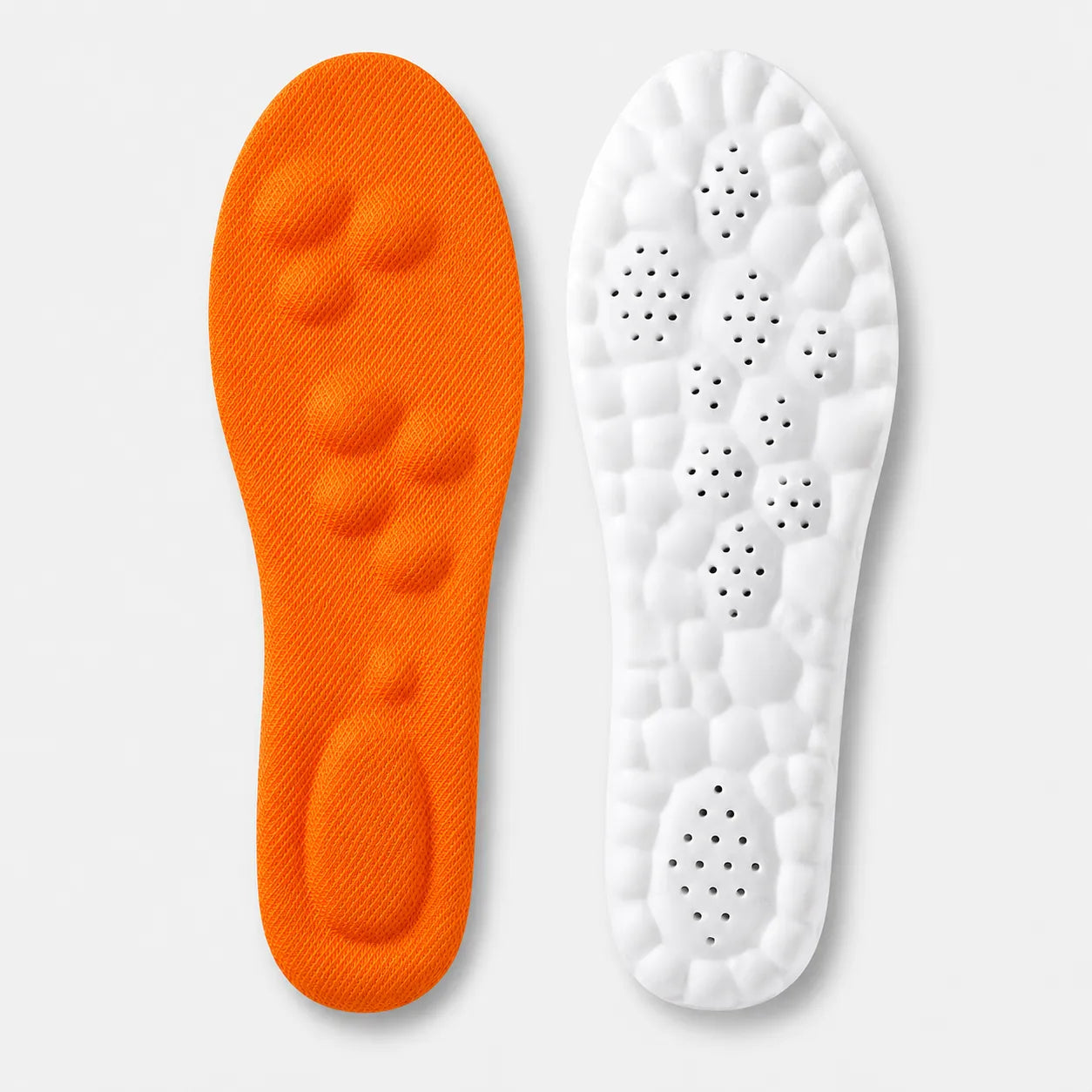 Orange and white shoe insoles on a light gray background